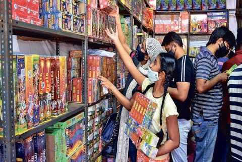Shoppers buy firecrackers at a store in Island Grounds