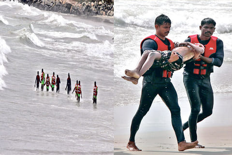 Fire and Rescue Services personnel and police searching the water to retrieve the bodies on Monday