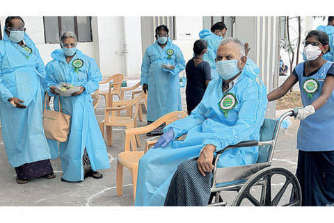 A recovered patient moves out after being discharged in Chennai