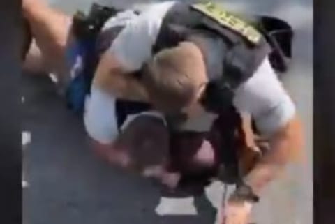 US cop on leave after 'pinning, punching' black man