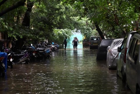 People passing through a flooded street in Chennai (File Photo)
