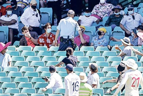 Police talk to spectators after a complaint by the players