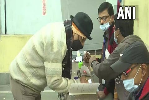 People cast their votes at Bidhannagar Govt. High school after thermal checking and sanitization