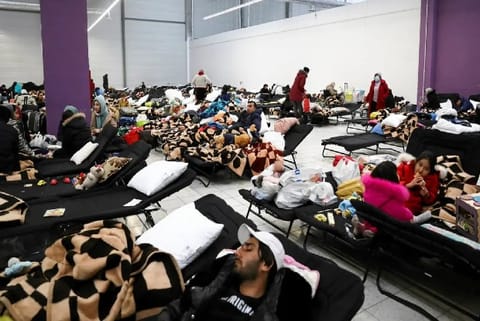 People fleeing Russian invasion of Ukraine, rest at a temporary accommodation centre/Reuters