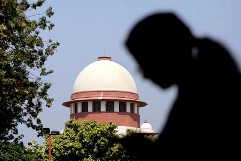 A woman checks her mobile phone inside the premises of the Supreme Court (Credit: Reuters)