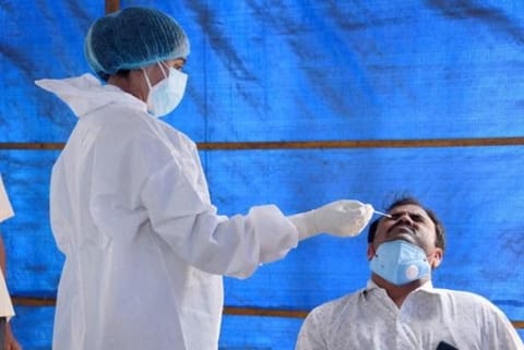 A health worker taking a swab sample (Image credit: PTI)