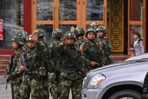 File photo shows security forces at the site of a bomb attack in Xinjiang