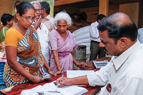 People waiting in a queue to add extra sheets to their existing ration cards