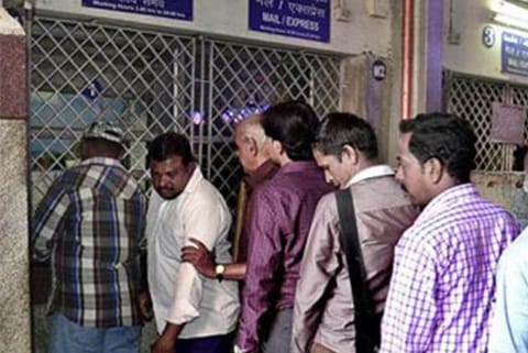 File photo of passengers waiting in front of a counter