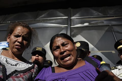 Relatives cry outside the children's shelter