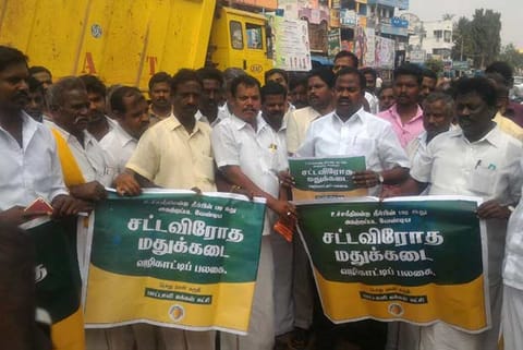 File photo of protestors display posters stating the outlets are illegal