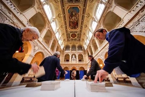 People select ballots as voting starts in the second round of 2017 French presidential election