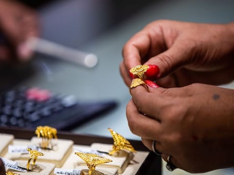 Shoppers browse gold jewellery at a Dubai market after prices rose Dh5.50 per gram in 24 hours, tracking gains in international bullion.