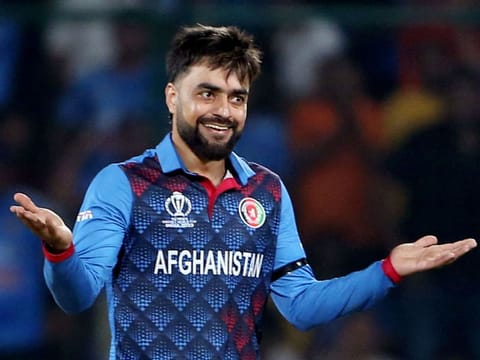 Afghanistan’s Rashid Khan celebrates the dismissal of India’s Ishan Kishan during the 2023 ICC Men's Cricket World Cup one-day international match at the Arun Jaitley Stadium in New Delhi on October 11, 2023. The leg-spinner claimed both the wickets that fell in the Indian innings.