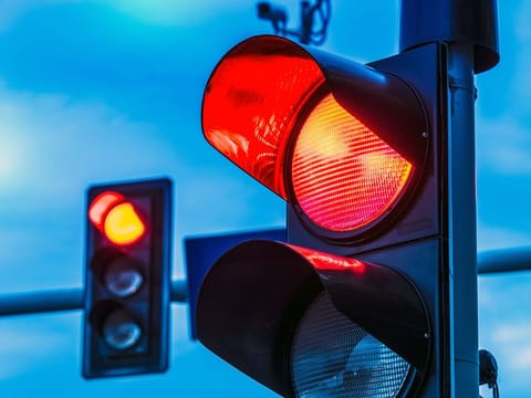 The crash occurred at dawn when the driver failed to stop at a traffic signal and struck a car carrying four people.