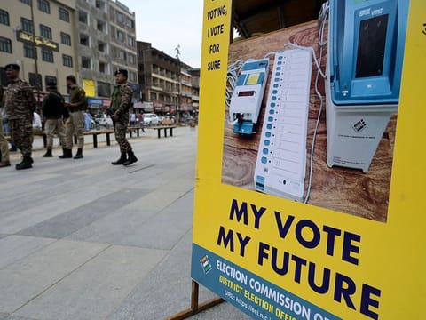 Indian security forces stands guard during an event organised by the the District Election Office to raise awarness about voting in India's upcoming general elections in Srinagar on April 13, 2024.