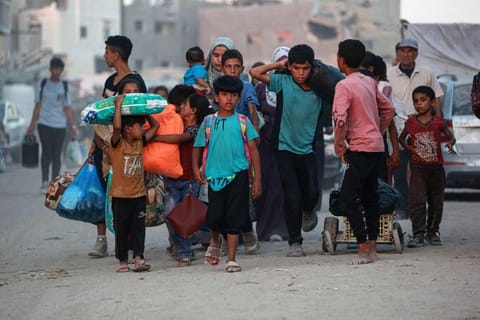 Children walk as displaced Palestinians leave an area in east Khan Yunis after the Israeli army issued a new evacuation order for parts of the city and Rafah, in the southern Gaza Strip on July 1, 2024, amid the ongoing conflict between Israel and the Palestinian Hamas militant group.