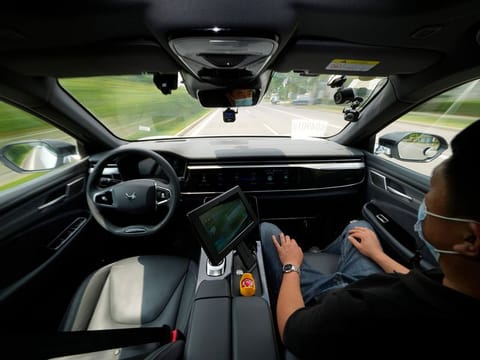 A technician monitors the self-driving taxi