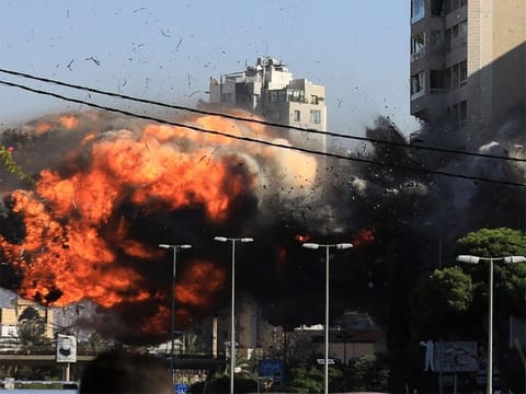 A building in Beirut's southern suburbs collapsed in a gigantic cloud of smoke and dust on Friday, an AFP photographer reported, as two strikes attributed to Israel hit the Hezbollah bastion. File photo.