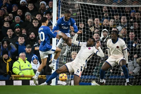 Everton's Senegalese striker Iliman Ndiaye, Portuguese striker Beto fight for possession with Chelsea's English defender Tosin Adarabioyo during the English Premier League football match at Goodison Park in Liverpool on December 22.