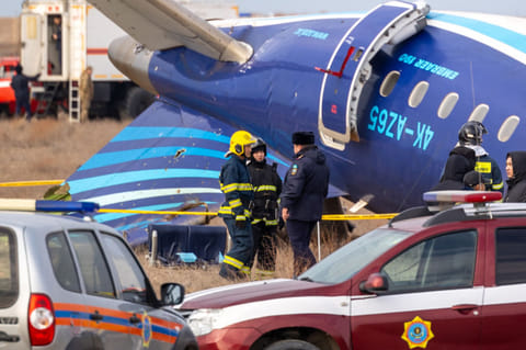 Emergency specialists work at the crash site of an Azerbaijan Airlines passenger jet near the western Kazakh city of Aktau on December 25, 2024.