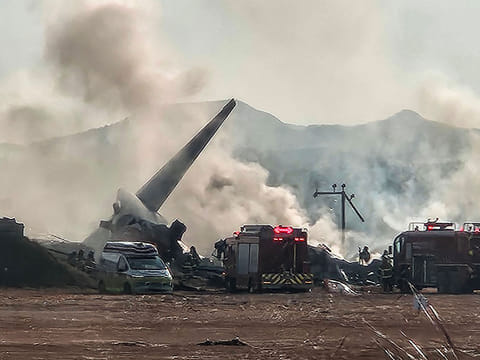 Smoke rises from the tail section of a Jeju Air Boeing 737-800 series aircraft after the plane crashed and burst into flames at Muan International Airport in South Jeolla Province, some 288 kilometres southwest of Seoul on December 29, 2024.