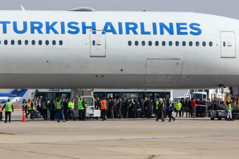 Passengers disembark from a Turkish Airlines aircraft carrying a diplomatic delegation from Ankara and an aid shipment provided by the Turkish Red Crescent, at the Damascus International Airport in the Syrian capital on January 23, 2025.