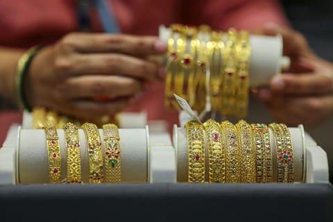 Gold bracelets for sale at a Kalyan Jewellers India store.