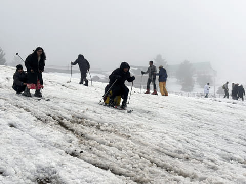 Tourists enjoy skiing on the snow-covered area after the upper reaches of Jammu & Kashmir receive fresh snowfall, at Gulmarg. Around 3.5 million tourists visited Kashmir in 2024, according to official figures, the majority domestic visitors.