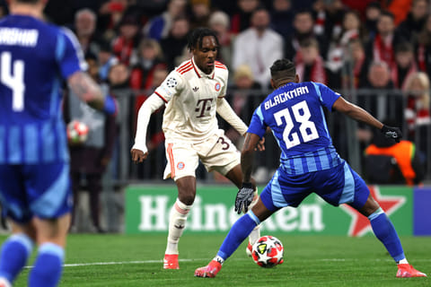Bayern Munich's French forward Mathys Tel (left) and Slovan Bratislava's Panamanian defender Cesar Blackman vie for the ball during a Uefa Champions League football match.