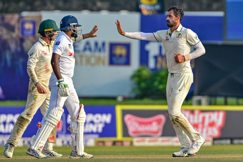 Australia's Mitchell Starc (right) celebrates with teammates after taking the wicket of Sri Lanka's Prabath Jayasuriya during the first day of the second Test cricket match at the Galle International Cricket Stadium in Galle on Thursday.