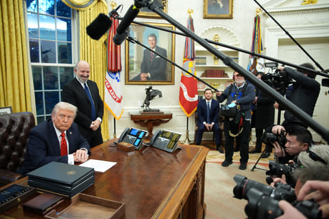 S. President Donald Trump, joined by Commerce Secretary Howard Lutnick, signs a series of executive orders in the Oval Office at the White House on February 10, 2025 in Washington, DC.