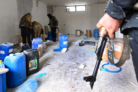Members of the Syrian security forces search a defunct drug factory inside an abandoned building near the village of Hawik in the countryside of Al Qusayr on February 12, 2025.
