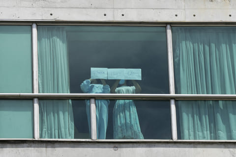 Migrants deported from the US place papers with a written message in the window of the Decapolis Hotel where they are temporarily staying in Panama City, February 18, 2024.