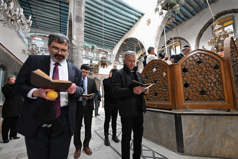 Visiting Jewish worshippers attend the first prayer since 1992, held in the Ifrange Synagogue in the Jewish quarter in Old Damascus' Bab Sharqi neighbourhood, on February 19, 2025.