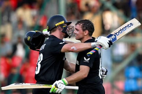 New Zealand's Tom Latham (right) celebrates with Glenn Phillips after scoring a century during the ICC Champions Trophy cricket against Pakistan at the National Stadium in Karachi on February 19.
