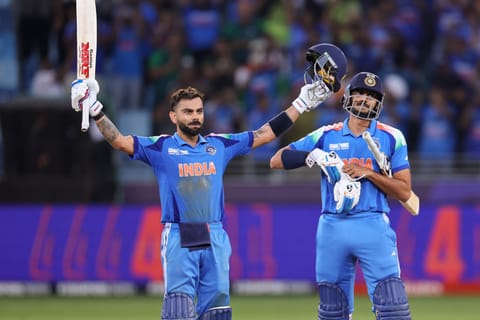 Indian batsman Virat Kohli celebrates his century and India’s win over Pakistan with Axar Patel in the Champions Trophy match at Dubai International Stadium on Sunday.