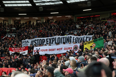 Fans hold a protest against rising ticket prices inside the ground ahead of the English FA Cup fifth round football match between Manchester United and Fulham at Old Trafford