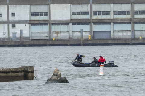 NYPD scuba divers team search next to the site of a crashed helicopter on the Hudson River on April 11, 2025 in Jersey City, New Jersey.