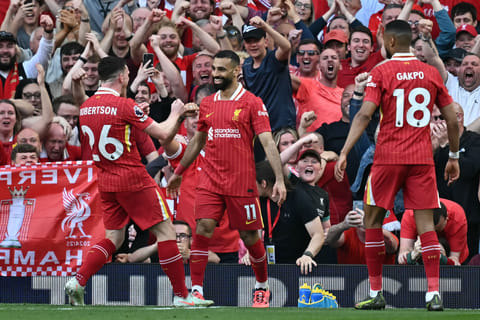 Liverpool's Egyptian striker #11 Mohamed Salah (C) celebrates with teammates after scoring their fourth goal during the English Premier League football match between Liverpool and Tottenham Hotspur at Anfield in Liverpool, north west England on April 27, 2025.