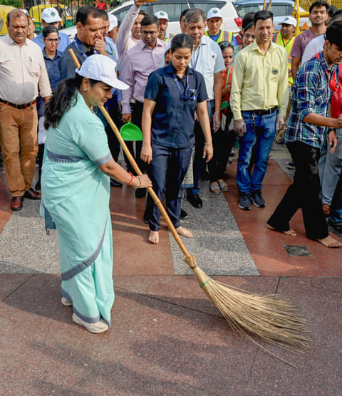 Delhi Chief Minister Rekha Gupta takes part in the cleanliness campaign organised by NDMC, on Pracheen Hanuman Temple complex in New Delhi on Tuesday.