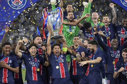 PSG players celebrate with the trophy after winning the Champions League final soccer match between Paris Saint-Germain and Inter Milan at the Allianz Arena in Munich, Germany.