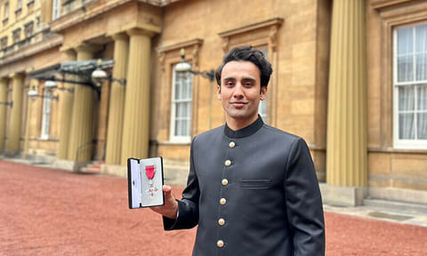 Bila Bin Saqib showinghis medal. He was awarded the Member of the British Empire (MBE) by King Charles, presented by Princess Anne.