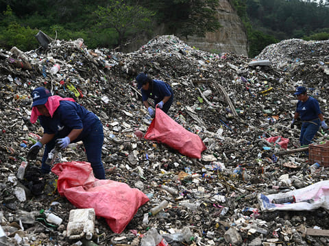Workers classify recyclable material at Las Vacas River in Chinautla, Guatemala on June 3, 2025.
