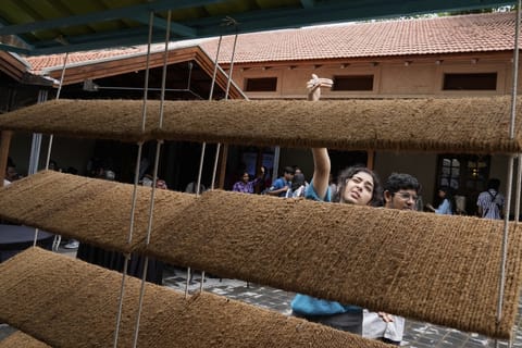 Ankritya Diggavi, one of the architects behind the design of Neralu, an innovative portable heat shelter, explains its features to visitors at the Sweat and Concrete 2025 event in Bengaluru, India, Thursday, May 29, 2025.