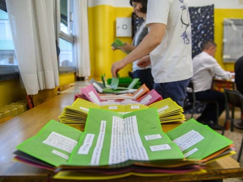 Ballot papers are prepared on a table for referendums on citizenship and job protections, at a polling station in Milan, Italy.