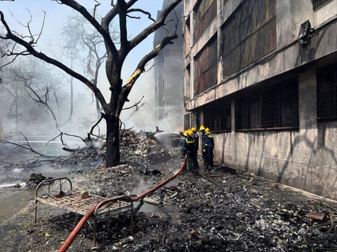Firefighters work at the site of an Air India plane that crashed in India's northwestern city of Ahmedabad in Gujarat state, Thursday, June 12, 2025