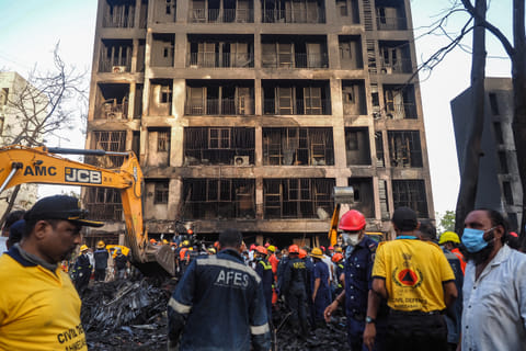 Rescue officials work at the site where Air India flight 171 crashed in a residential area near the airport in Ahmedabad on June 12, 2025.