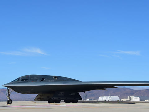 A B-2 Stealth Bomber pulls up on the runway after landing at the Palmdale Aircraft Integration Center of Excellence in Palmdale, California on July 17, 2014, where the US Air Force and manufacturer of the B-2, Northrop Grumman, celebrated the 25th anniversary of the B-2 Stealth Bomber's first flight.
