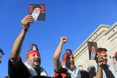 Supporters of Lebanon's Hezbollah hold pictures Iran's supreme leader Ayatollah Ali Khamenei, during a rally outside the Iranian Embassy in Beirut’s southern suburbs, to celebrate a ceasefire between Israel and Iran, on June 25, 2025.